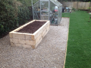 After renovation. New lawn laid, new gravel area and raised bed